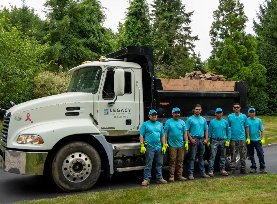 The Legacy Mason Contractors crew in front of their work truck loaded with stone